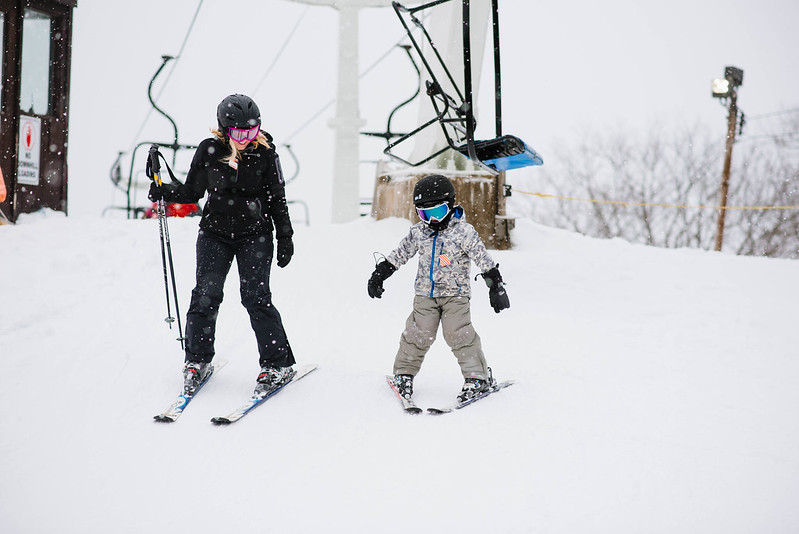 photo of woman and child skiing
