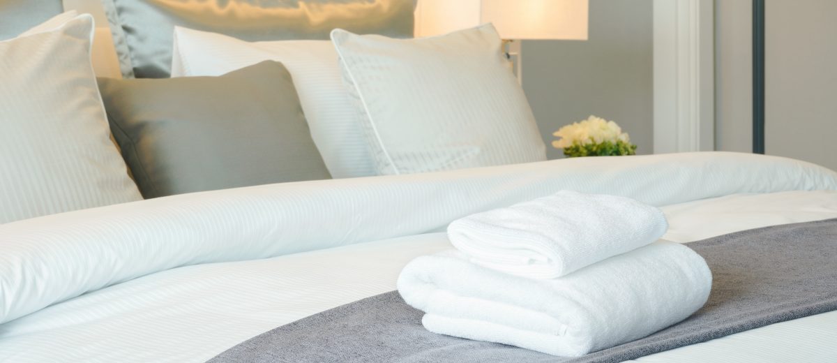 photo of clean towels on bed at hotel room